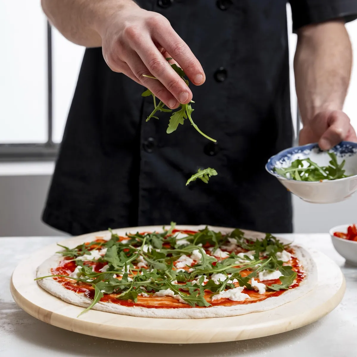 Adding arugula to pizza